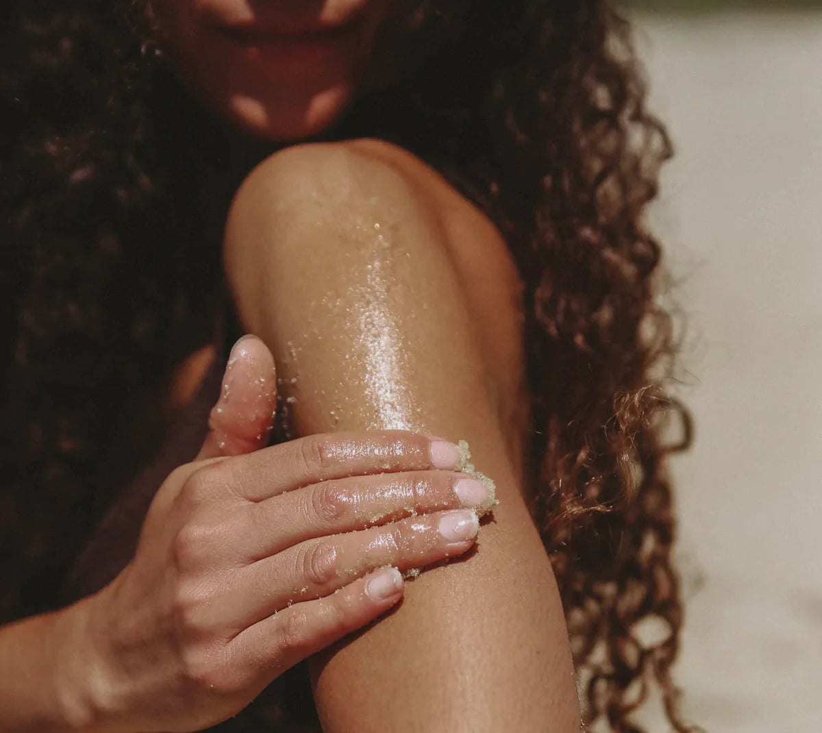Circular Living Sea Salt Body Scrub with Green Tea and Eucalyptus being used by model with glowing skin.