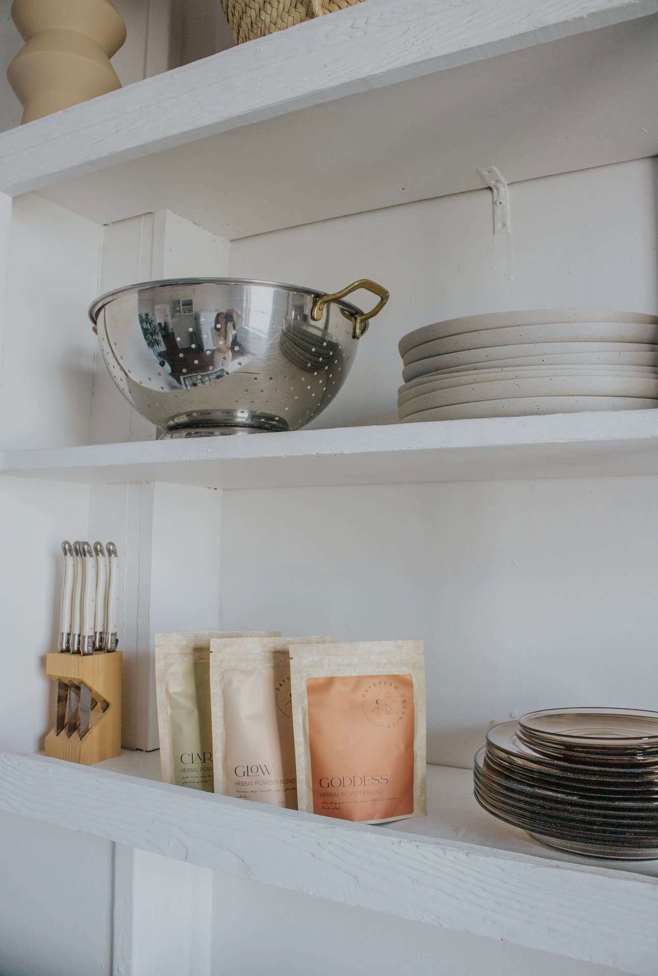 Daydream Organics Herbal Powder Blend pouch placed neatly on a white shelf with other herbal blends.