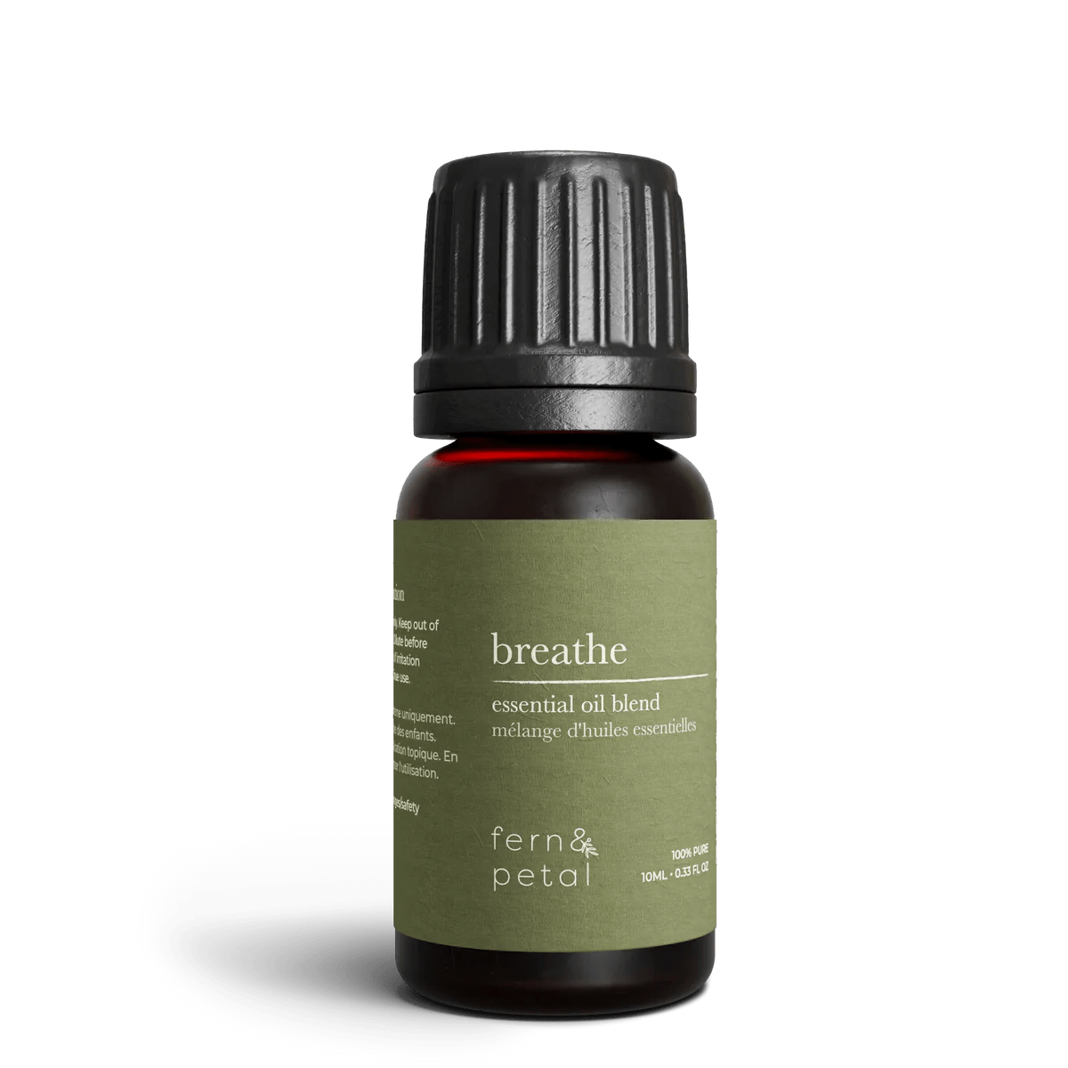 Close-up of Fern & Petal Breathe Essential Oil Blend bottle showing green label details.