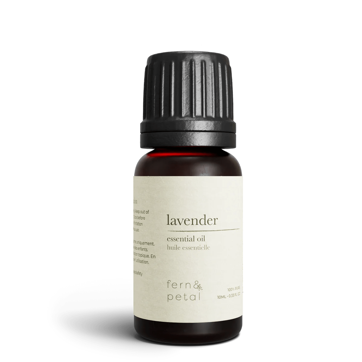 Close-up of Fern & Petal Lavender Essential Oil bottle with product details visible.