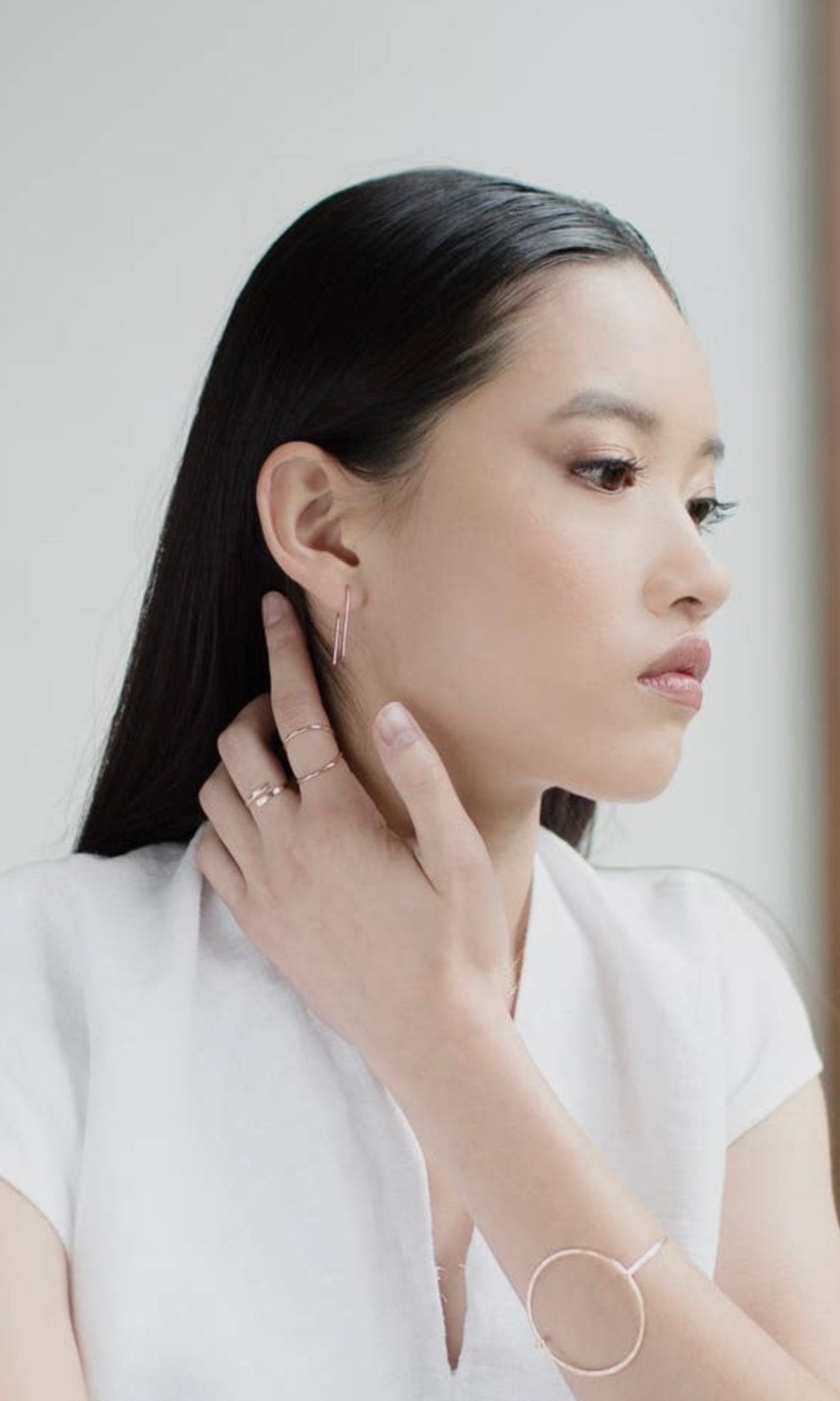 Model wearing Token Jewelry Coil Ring in gold, styled with minimal jewelry.