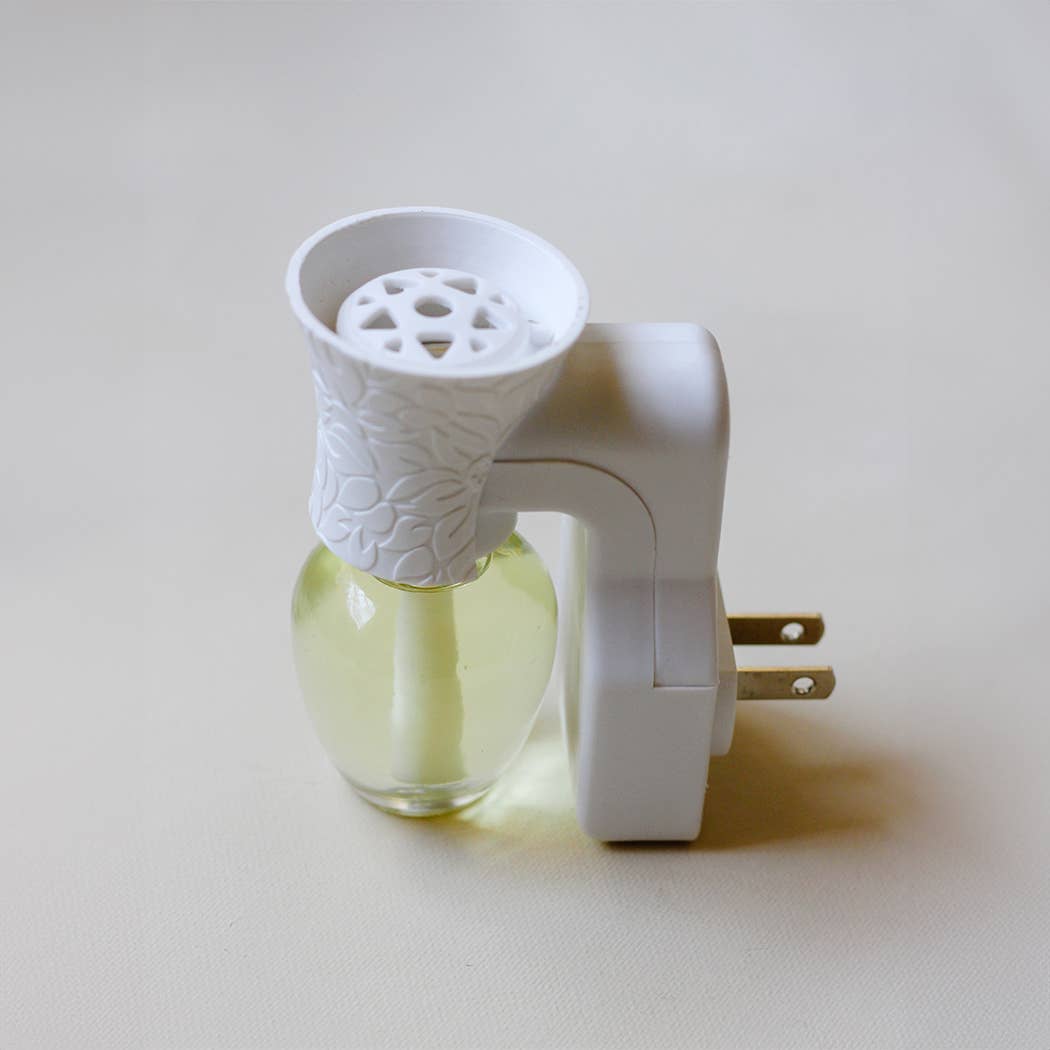 Side view of a white Well-Taylored Wall Diffuser Plug-In with attached fragrance refill.