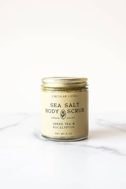 Circular Living Sea Salt Body Scrub with Green Tea and Eucalyptus styled on marble, natural skincare exfoliator.