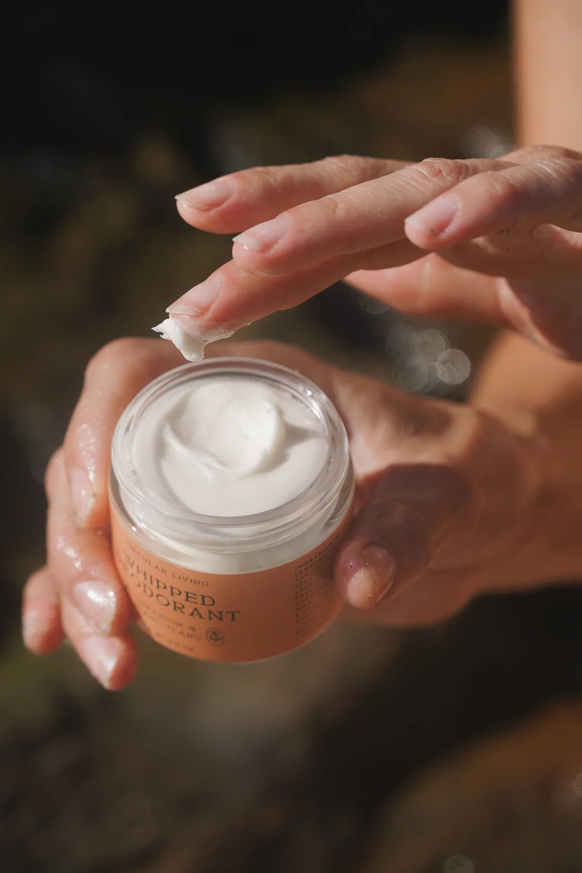 Circular Living Whipped Deodorant Geranium and Ylang Ylang texture being scooped outdoors.