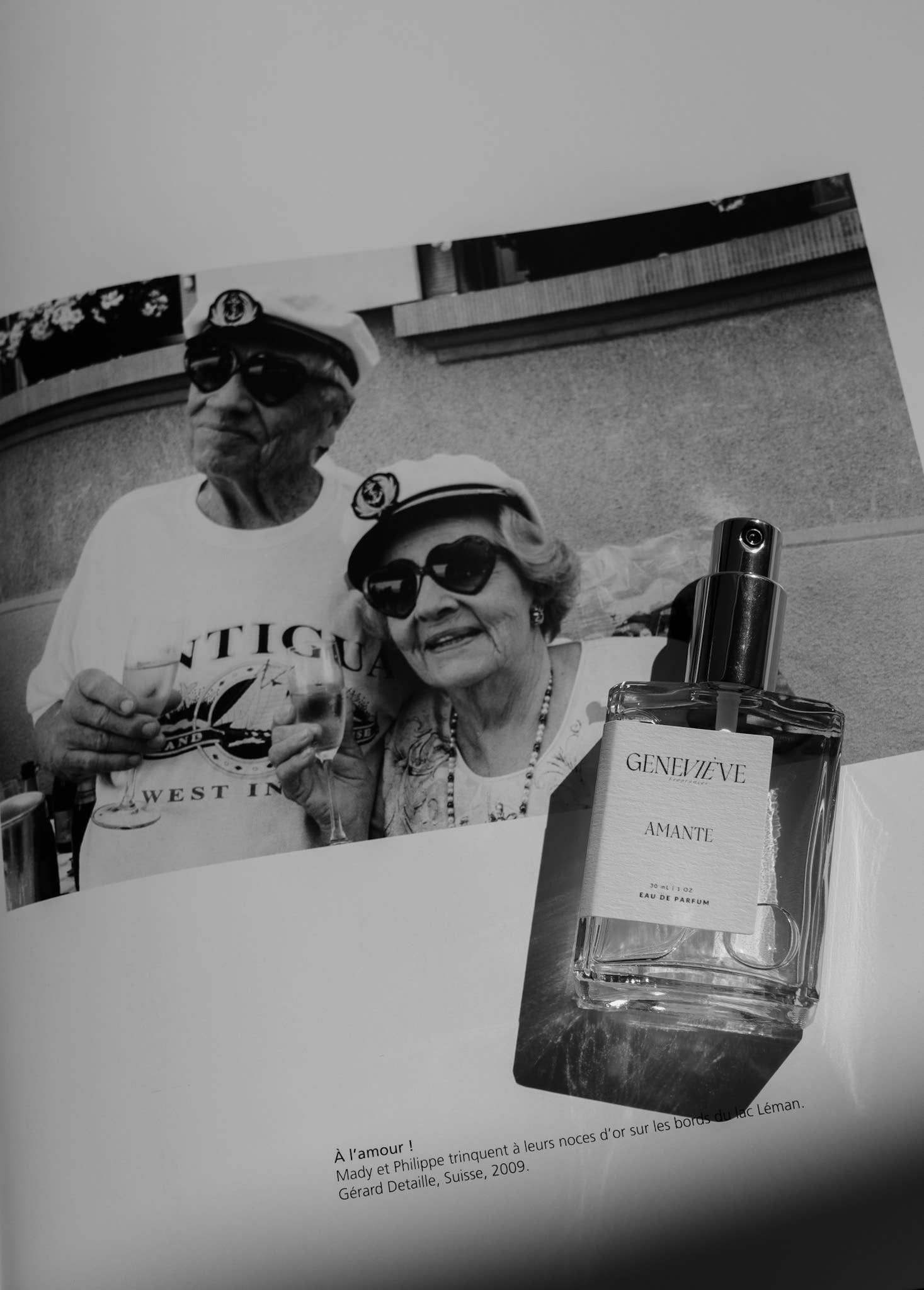 Genevieve Fragrances Amante perfume bottle resting on a black-and-white photograph.