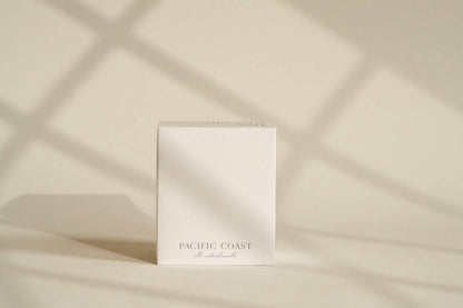Minimalist candle box packaging by Orchid & Ash with soft shadow lines.