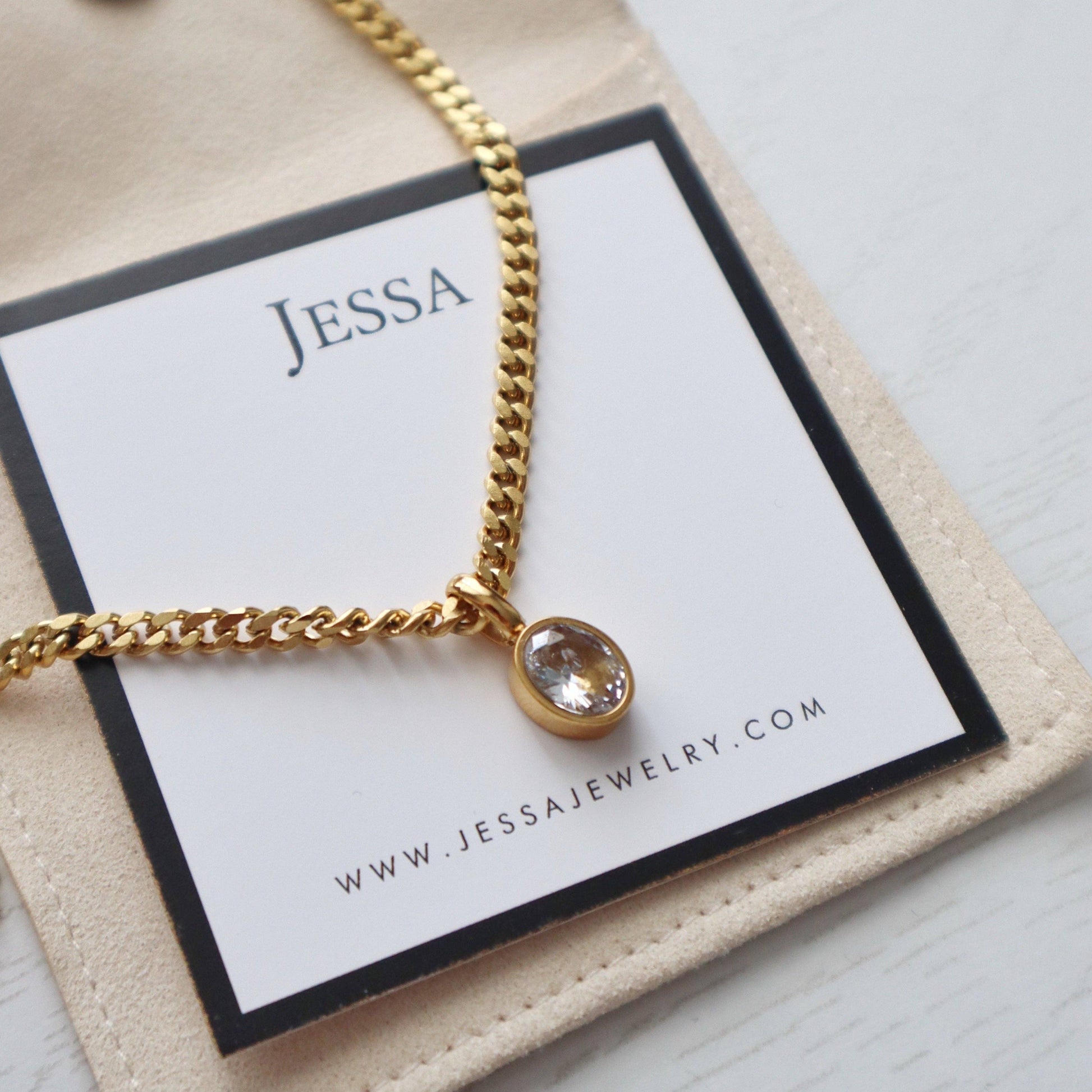 JESSA Jewelry necklace styled on branded card, highlighting gemstone and gold chain.