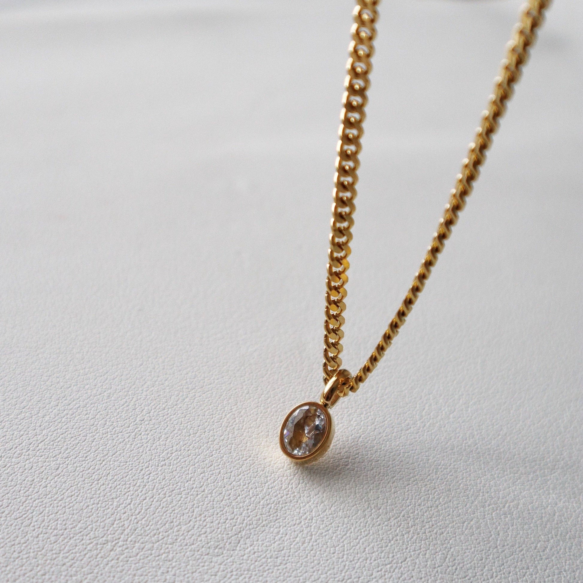 Side angle of JESSA Jewelry chain necklace showing gem detail and gold setting.
