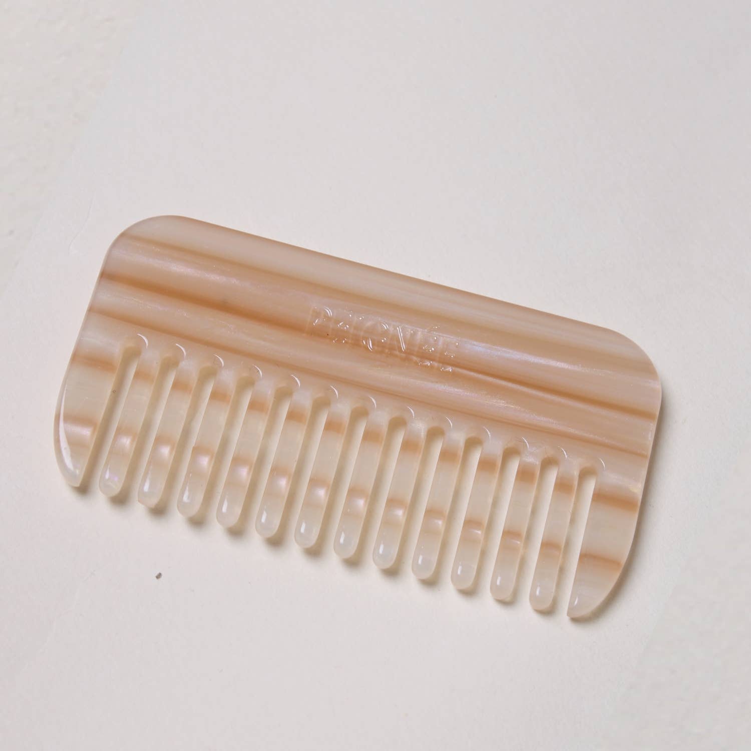 Top view of the Peignée Paris travel comb in Latte with soft neutral tones.