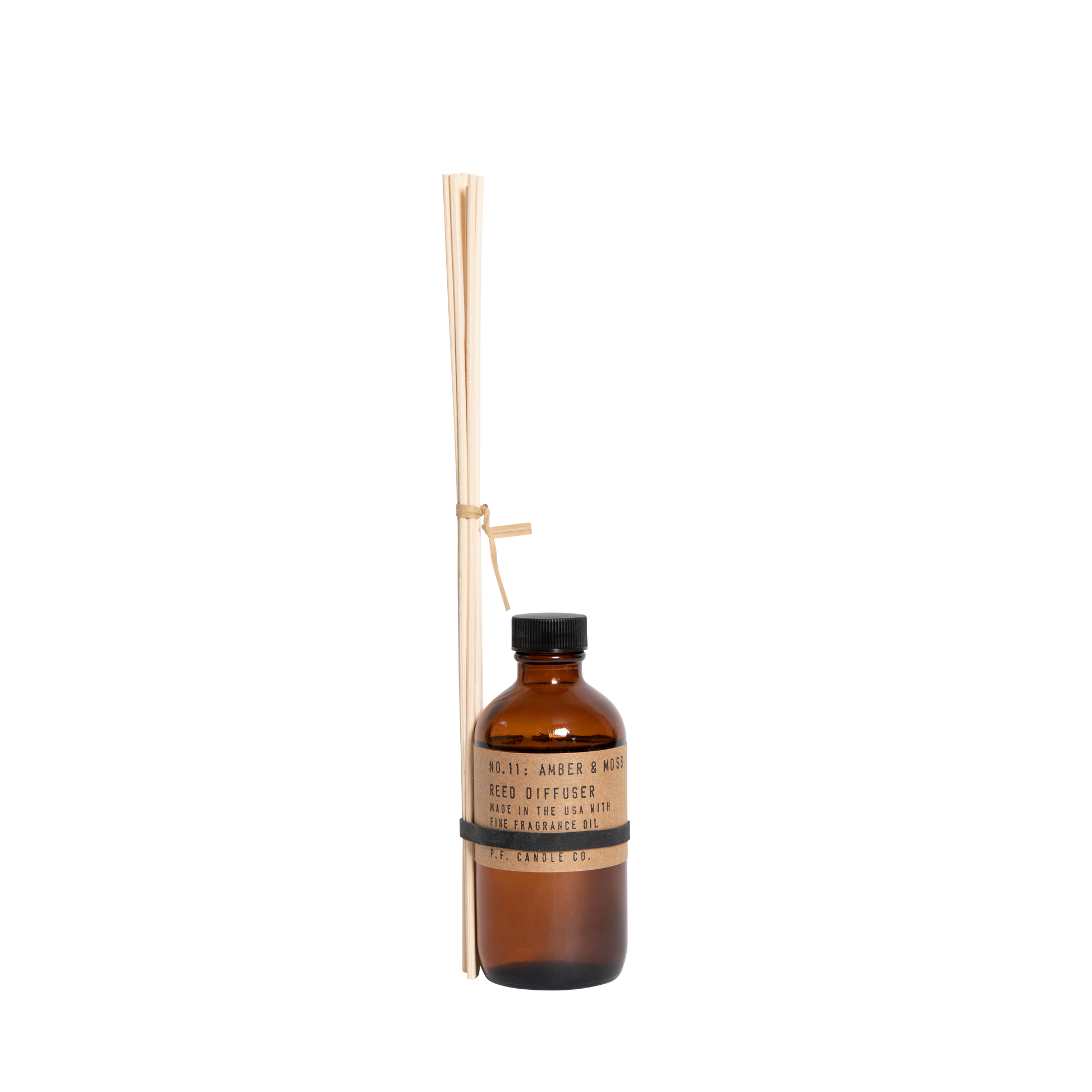 P.F. Candle Co. Amber & Moss reed diffuser with bundled diffuser sticks tied to the bottle.
