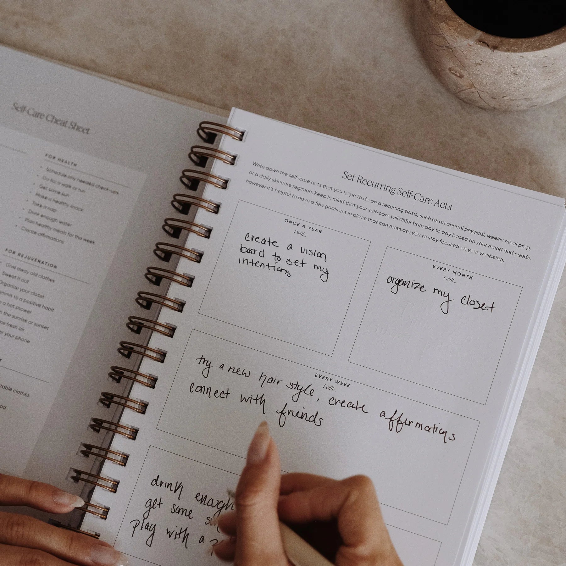 Person writing recurring self-care acts in The Self Care Planner, adding personal routines and wellness ideas.