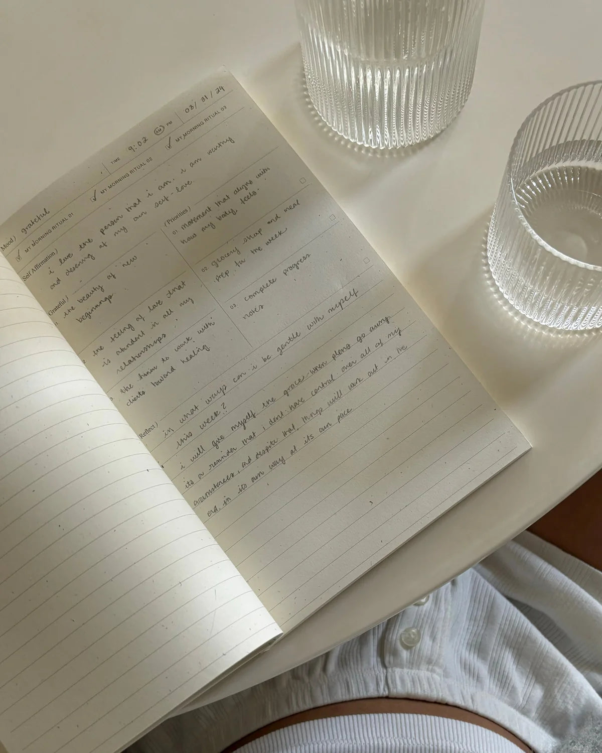 Wilde House Paper Morning Routine Journal open with handwritten morning routine reflections.