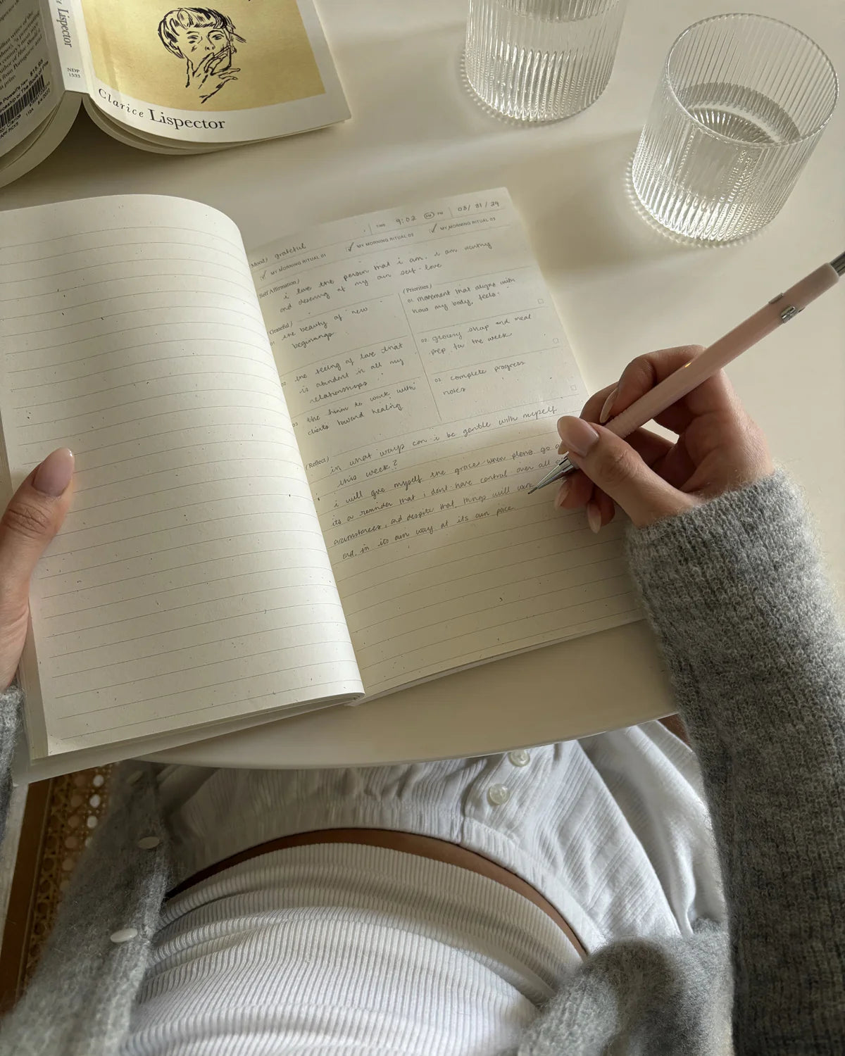 Wilde House Paper Morning Routine Journal open to lined pages with personal reflections being written.