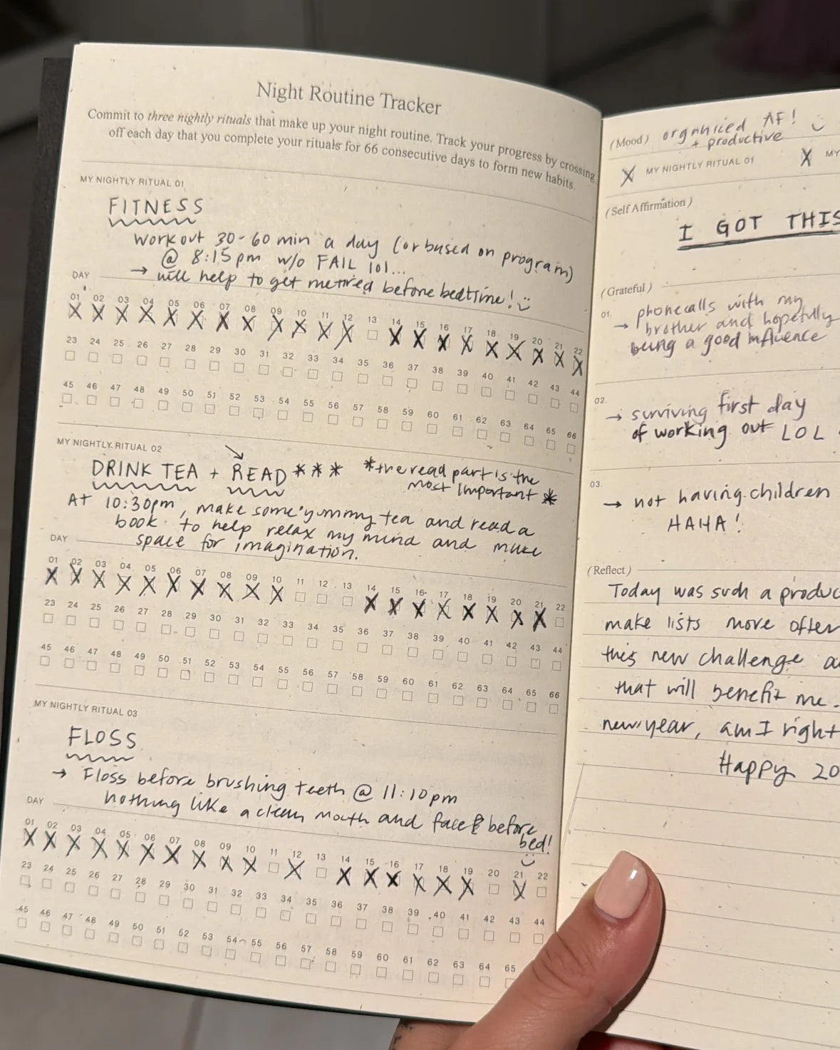 Wilde House Paper Night Routine Journal open with handwritten entries in nightly tracker and journal pages.