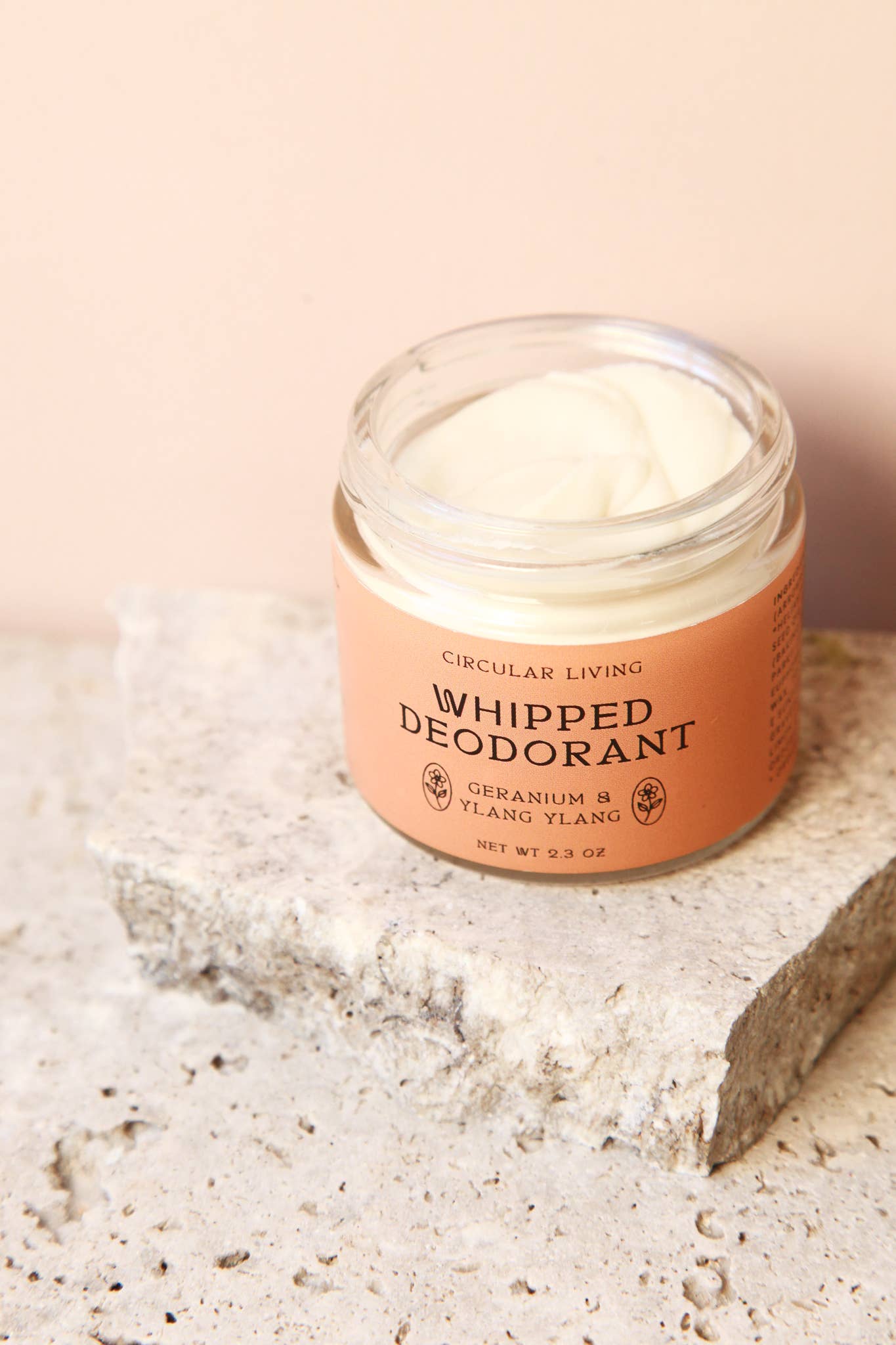 Circular Living Whipped Deodorant Geranium and Ylang Ylang open jar resting on a natural stone surface.