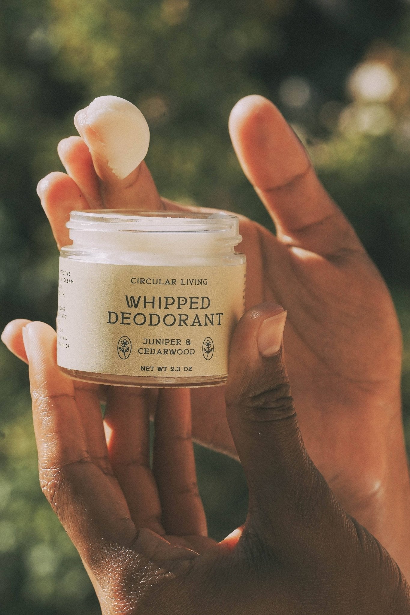Open jar of Circular Living Whipped Deodorant Juniper and Cedarwood being scooped by hand.