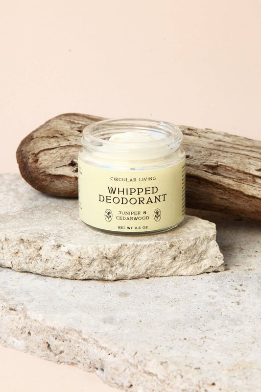 Circular Living Whipped Deodorant Juniper and Cedarwood resting on natural stone with driftwood styling.