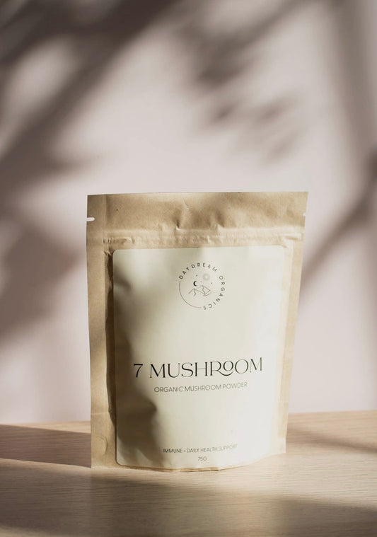 Daydream Organics 7 Mushroom Powder pouch on table with natural sunlight.