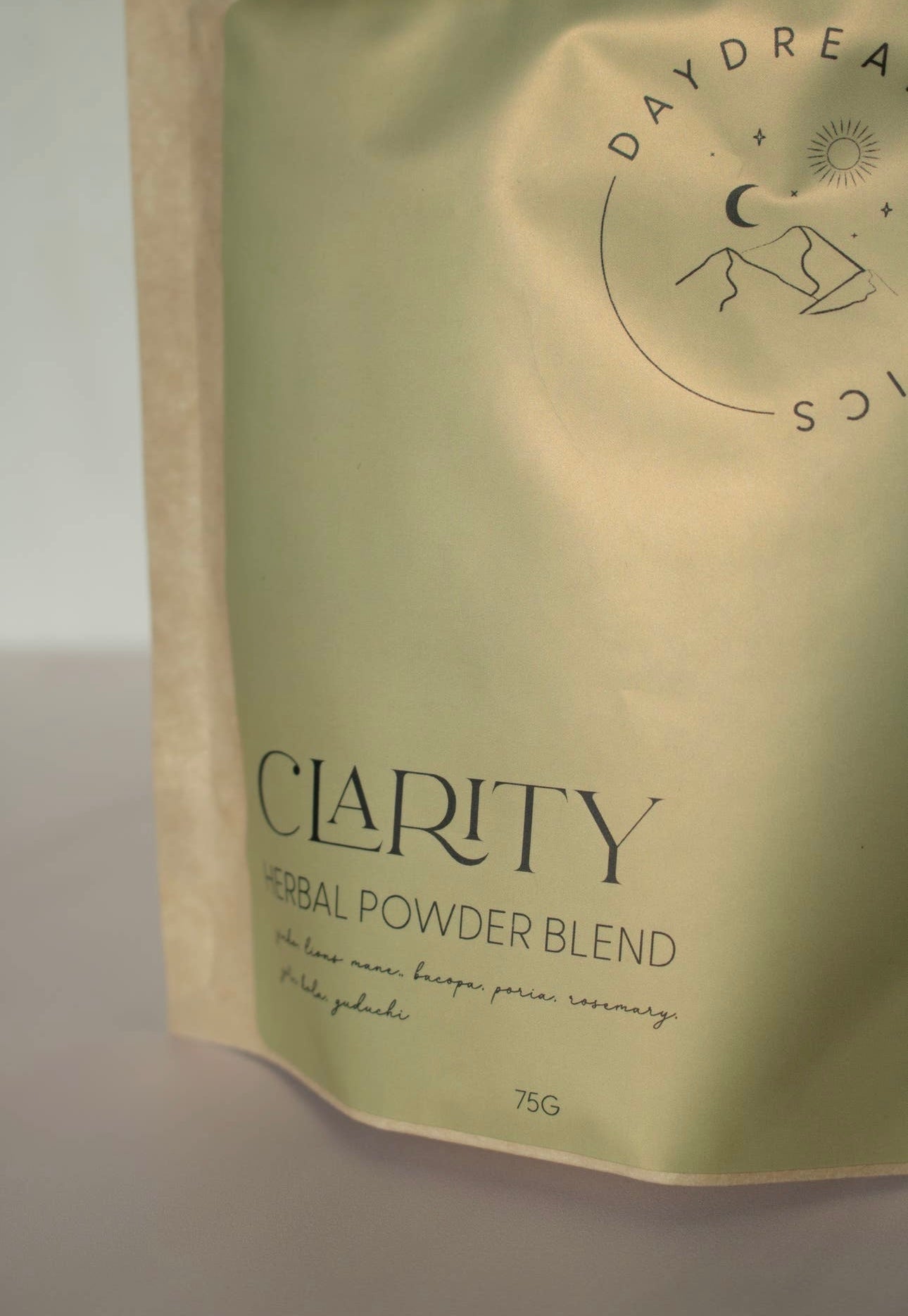 Daydream Organics Clarity Herbal Powder Blend close-up image of green label on a neutral background.
