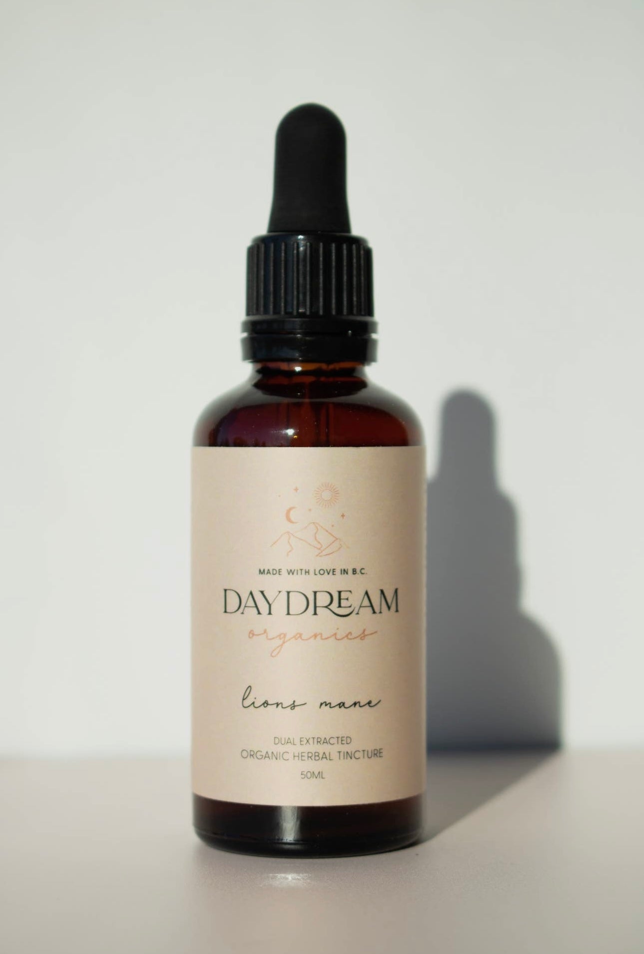 Close-up of Lion’s Mane mushroom tincture bottle by Daydream Organics against a white background.