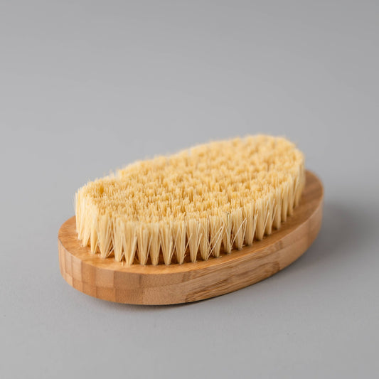 Detoxifying dry body brush with natural bristles and bamboo handle.