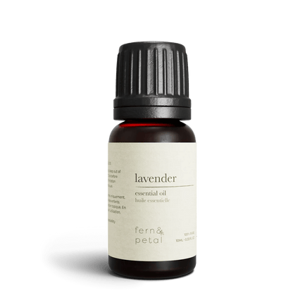 Close-up of Fern & Petal Lavender Essential Oil bottle with product details visible.