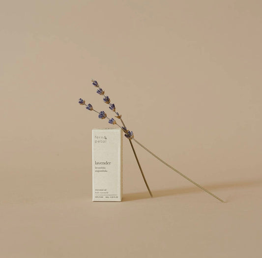 Fern & Petal Lavender Essential Oil box displayed with a lavender stem on a neutral background.

