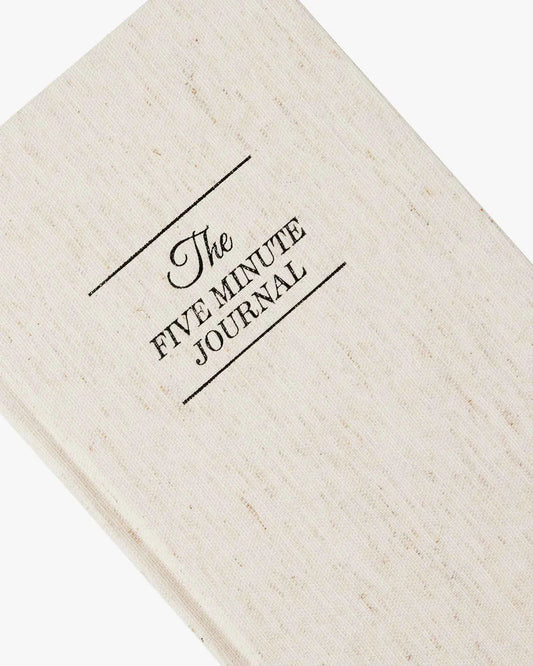 Close-up of The Five Minute Journal hardcover fabric cover with Best Seller badge.