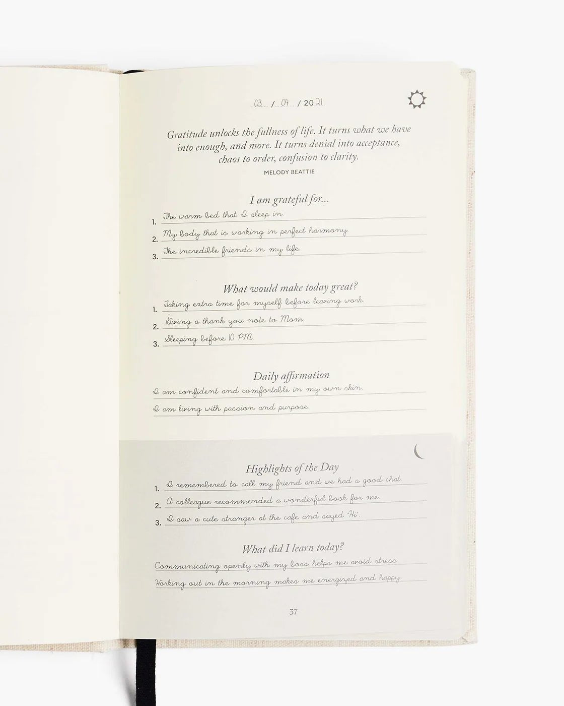 Open page of The Five Minute Journal showing daily gratitude and affirmation prompts.