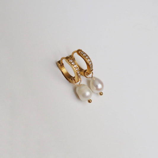 JESSA Jewelry CZ Huggies with Pearl Drop shown flat featuring gold hoops and dangling pearls.
