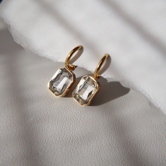 JESSA Jewelry Naomi Hoops with clear, white zircon stones styled on a soft neutral surface.