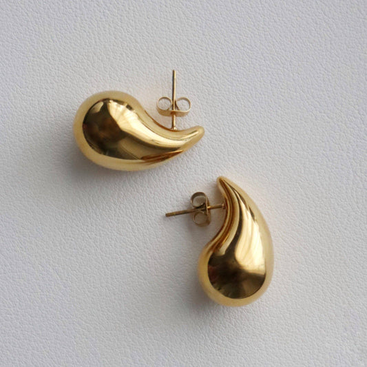 JESSA Jewelry Waterdrop Earrings shown lying flat with soft shadow on a smooth surface.