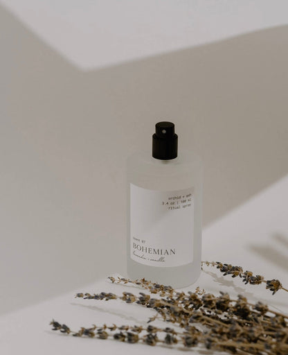 Orchid & Ash Bohemian spray with lavender sprigs casting shadows on a minimal background.