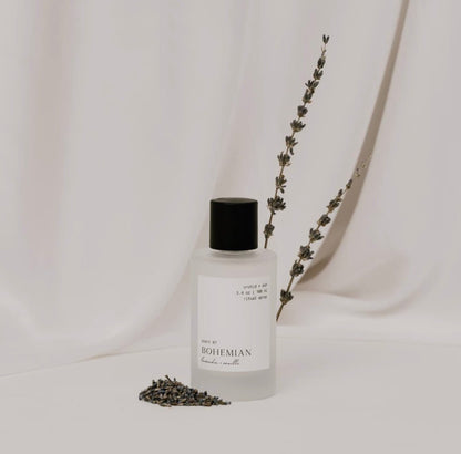 Bohemian room spray by Orchid & Ash standing beside dried lavender on a soft ivory backdrop.