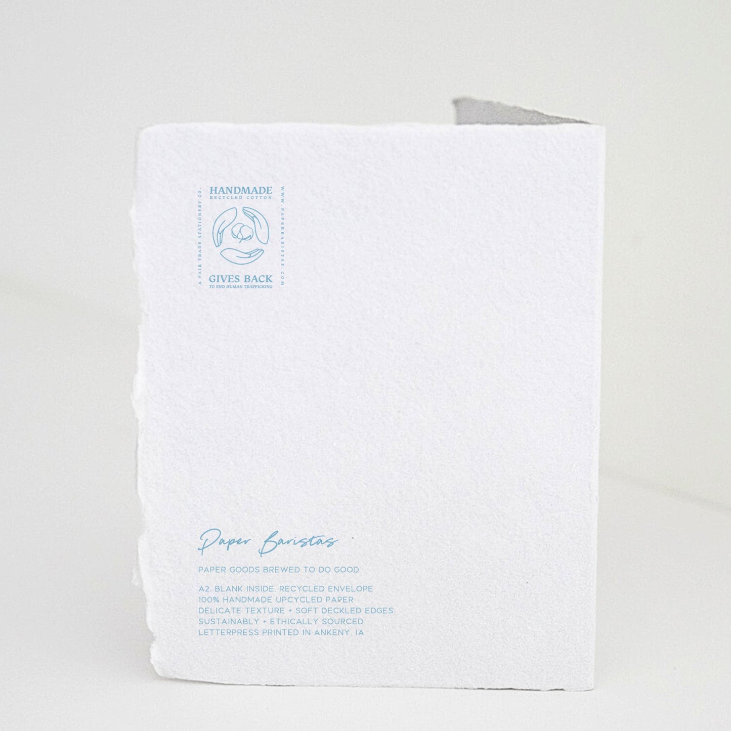 Back of Paper Baristas "Bundle of Joy Boy" greeting card with letterpress details and ethical production message in blue ink.