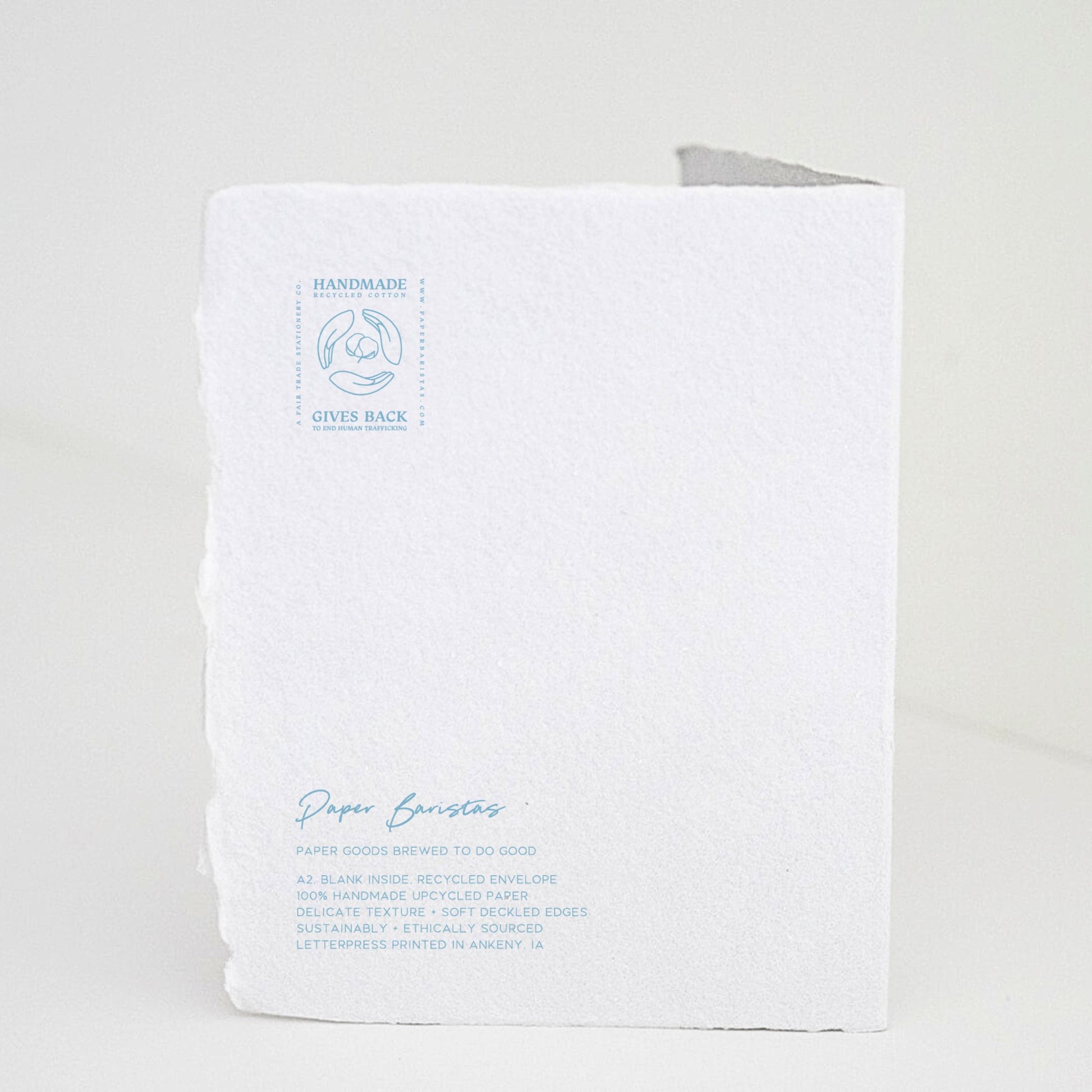 Back of Paper Baristas "Bundle of Joy Boy" greeting card with letterpress details and ethical production message in blue ink.
