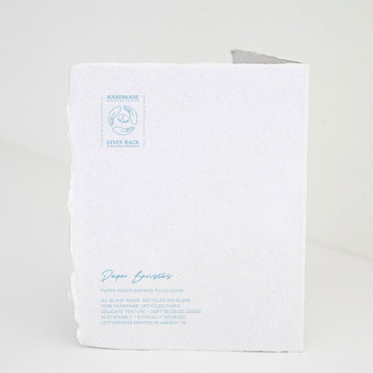 Back of Paper Baristas "Bundle of Joy Boy" greeting card with letterpress details and ethical production message in blue ink.