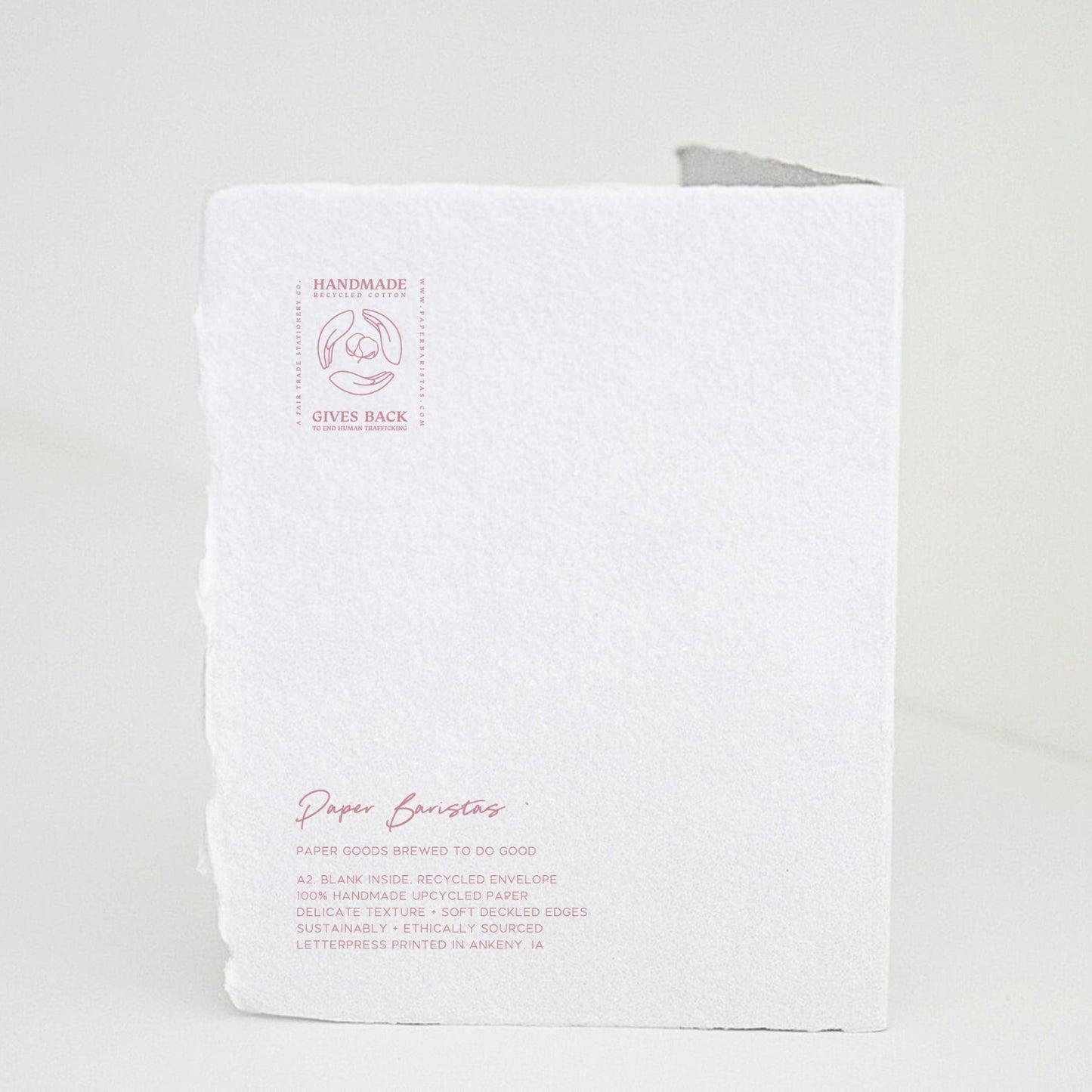 Back of Paper Baristas "Bundle of Joy Girl" greeting card with letterpress details and ethical production message in pink ink.