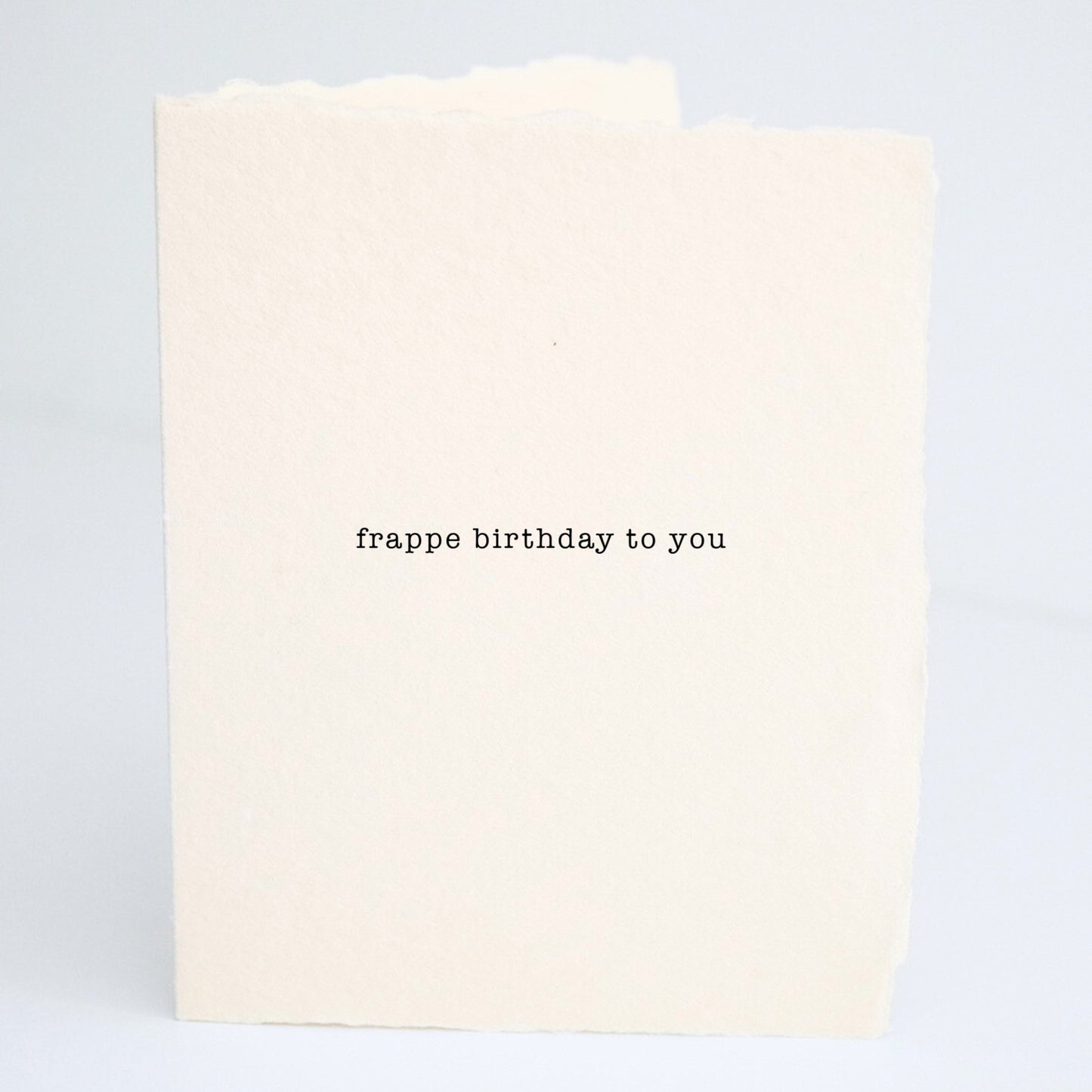 Front of Paper Baristas birthday greeting card with the phrase “Frappe Birthday To You” printed on cream cotton paper in black ink.