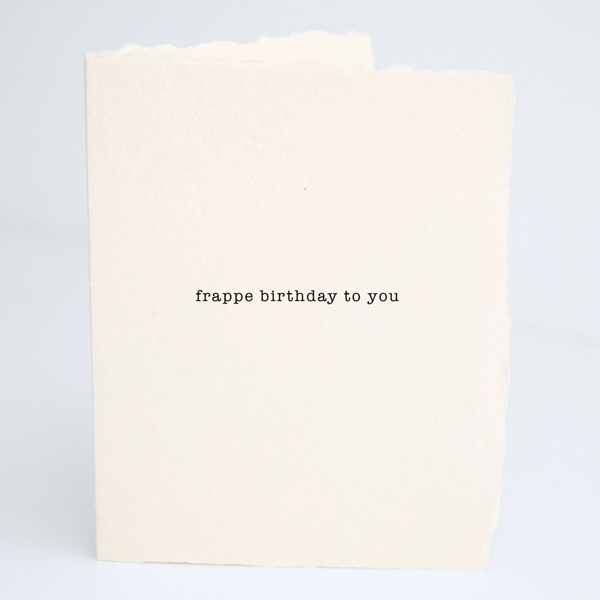 Front of Paper Baristas birthday greeting card with the phrase “Frappe Birthday To You” printed on cream cotton paper in black ink.