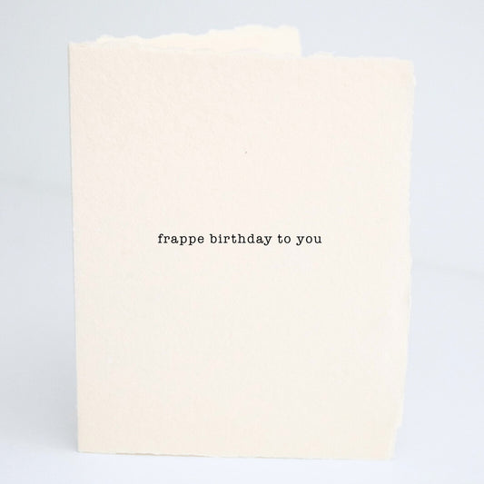 Front of Paper Baristas birthday greeting card with the phrase “Frappe Birthday To You” printed on cream cotton paper in black ink.