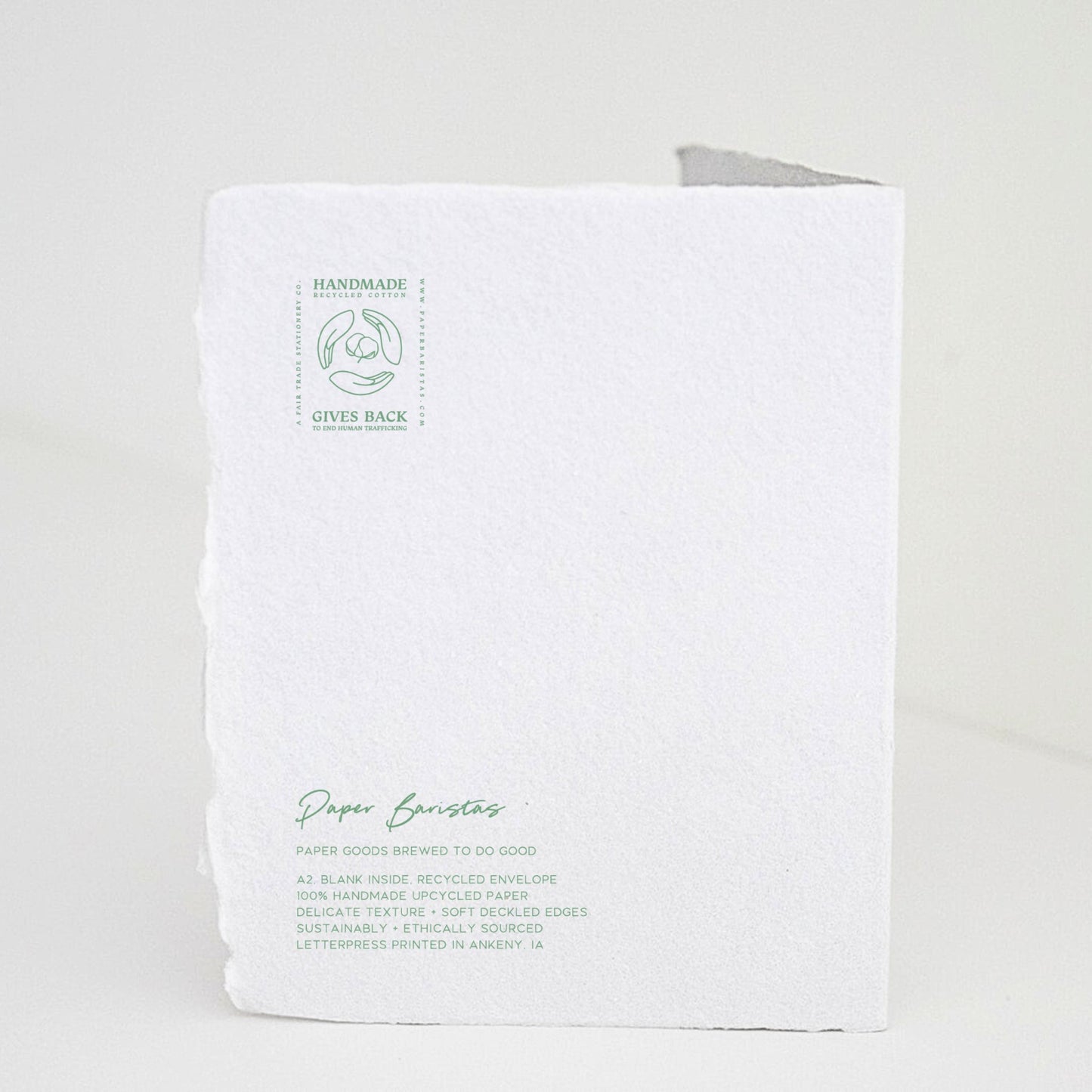 Back of Paper Baristas holiday "With Love and Peace" greeting card with letterpress details and ethical production message in green ink.
