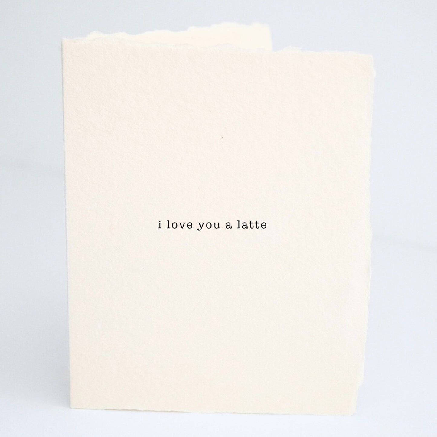 Front of Paper Baristas card with the minimalist message “I Love You a Latte” on soft cream cotton paper in black ink.
