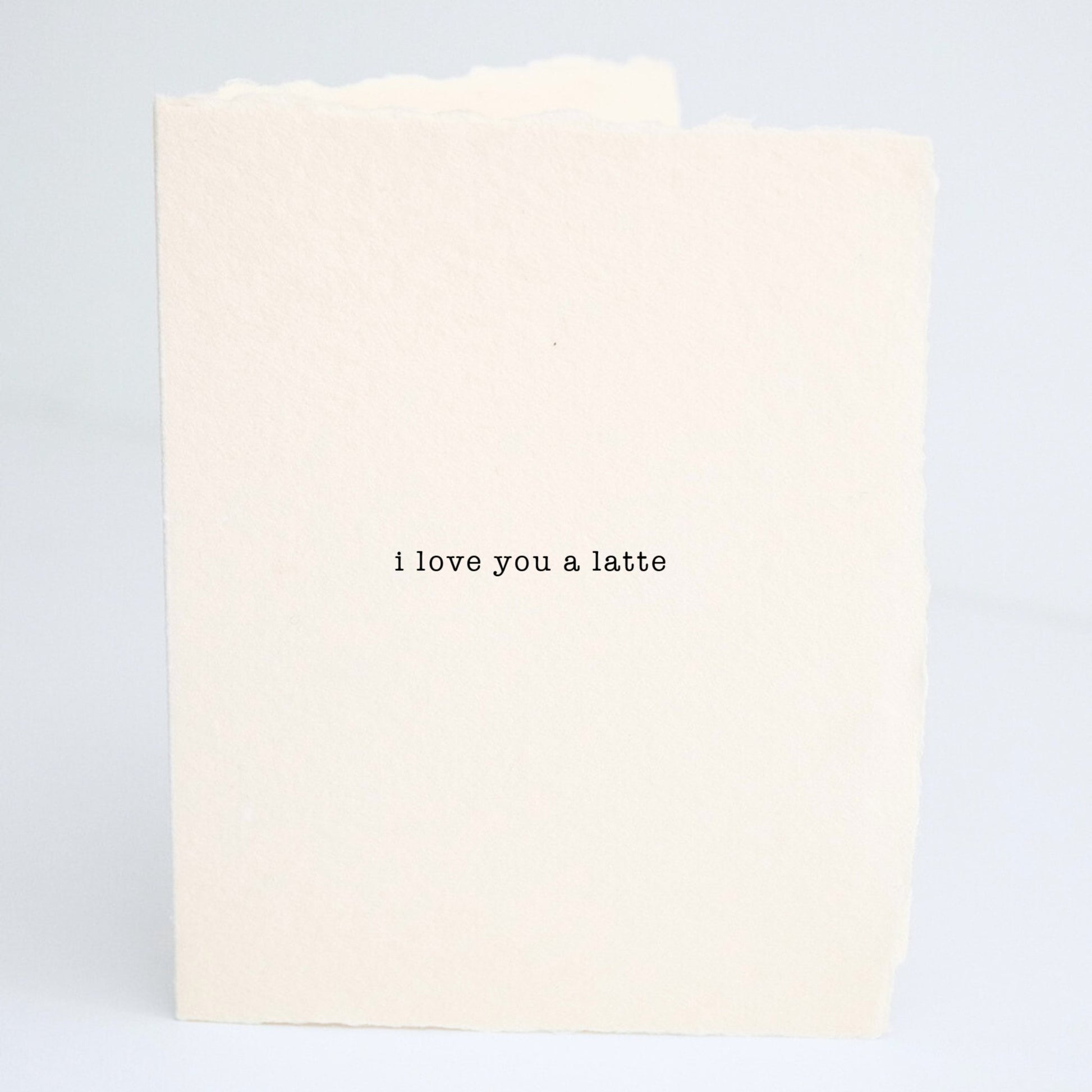 Front of Paper Baristas card with the minimalist message “I Love You a Latte” on soft cream cotton paper in black ink.
