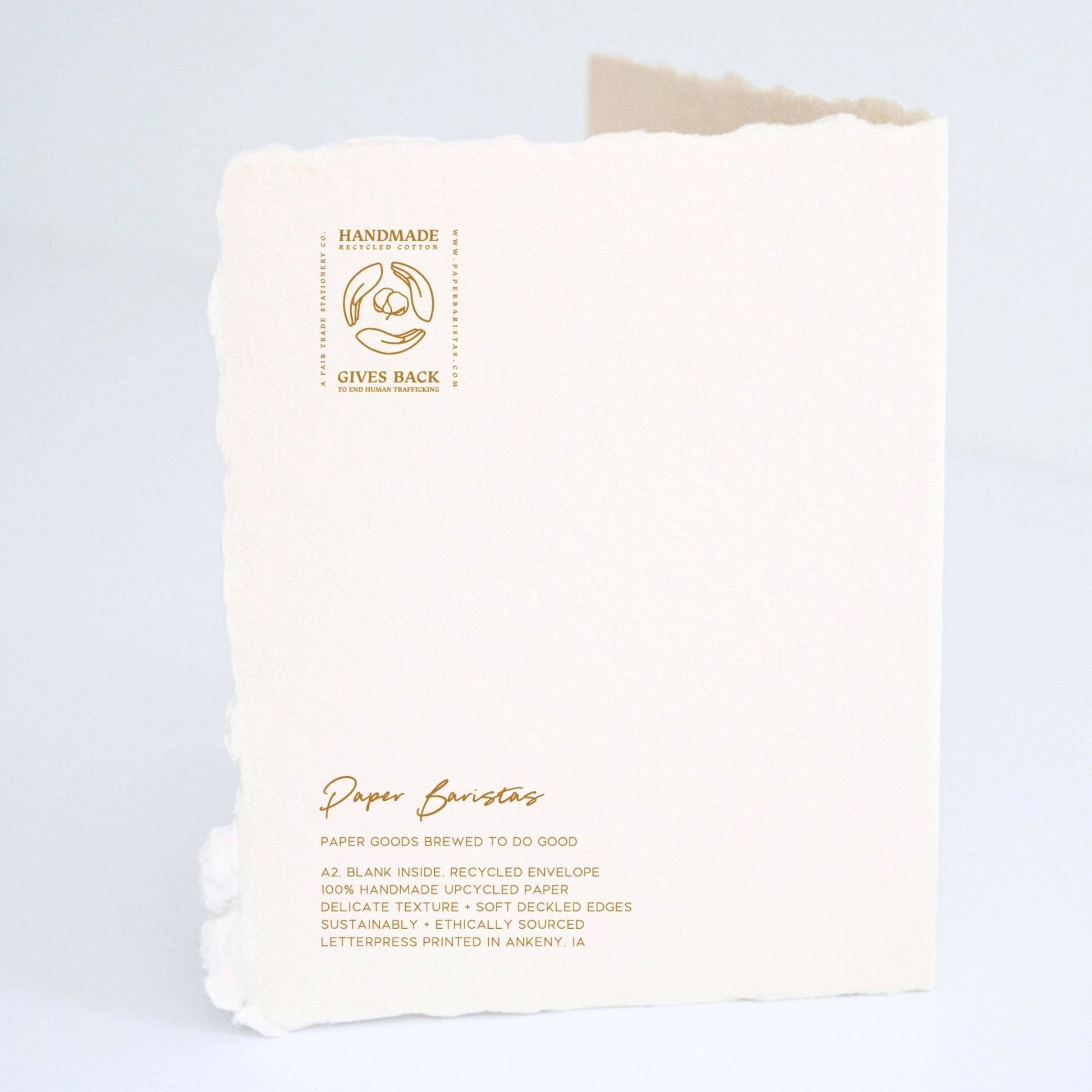 Back of Paper Baristas "Your Love Story Is One For The Ages, Cheers" greeting card with letterpress details and ethical production message.