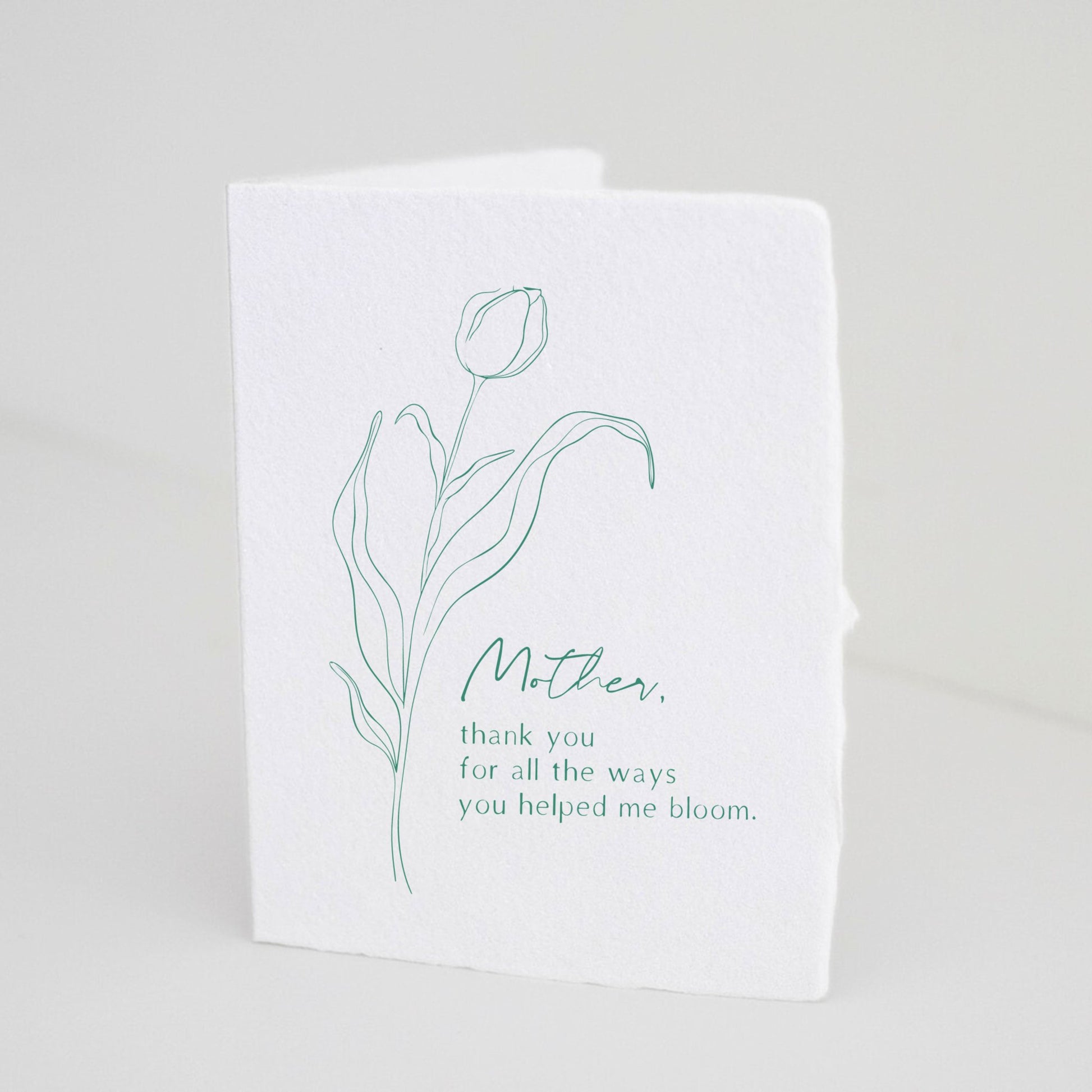 Front of Paper Baristas card with green tulip line drawing and the message “Mother, Thank You For All The Ways You Helped Me Bloom.”