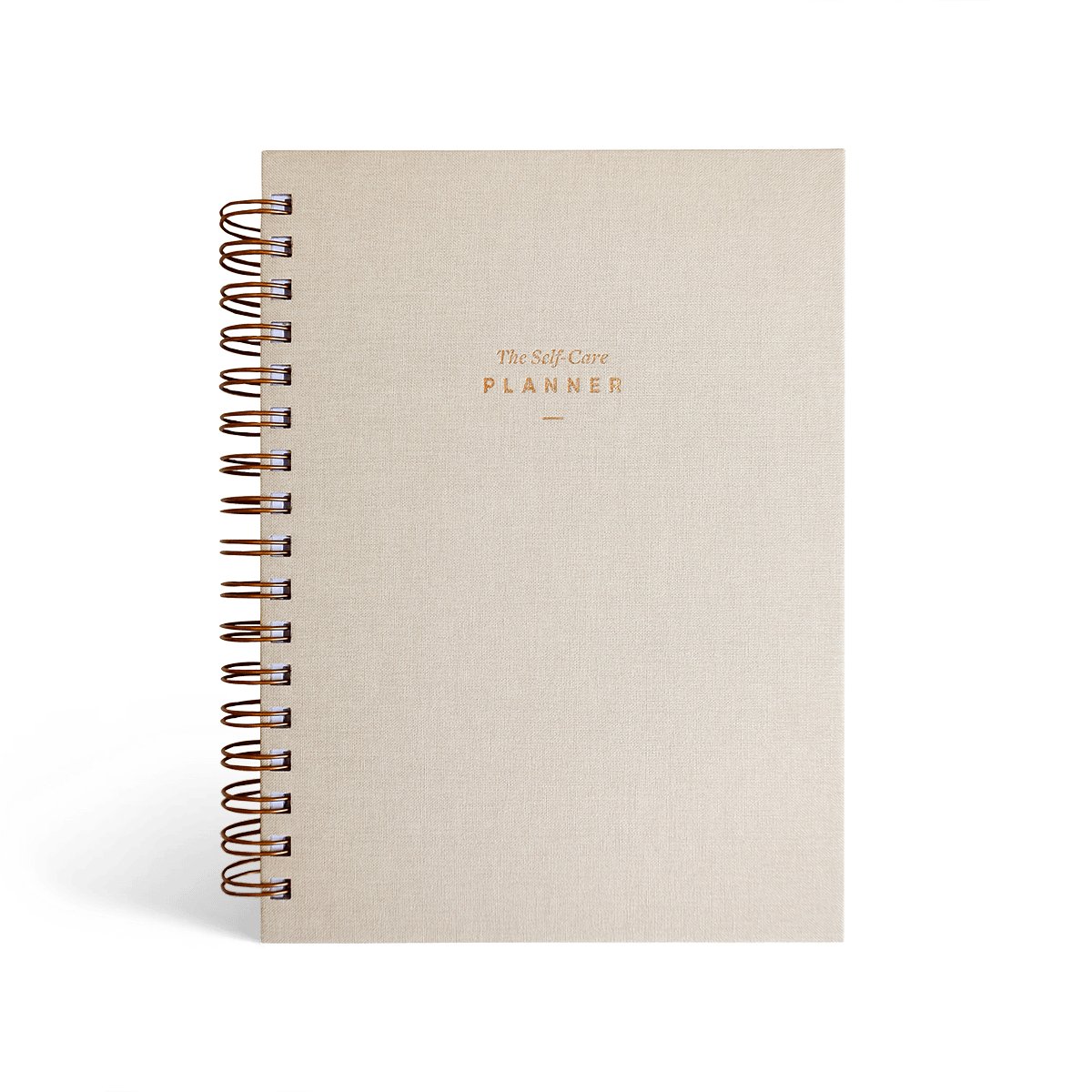 The Self Care Planner Weekly Edition in sand color, front cover with gold foil text.