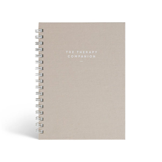 The Therapy Companion journal by Simple Self Co with sand linen cover, spiral bound.