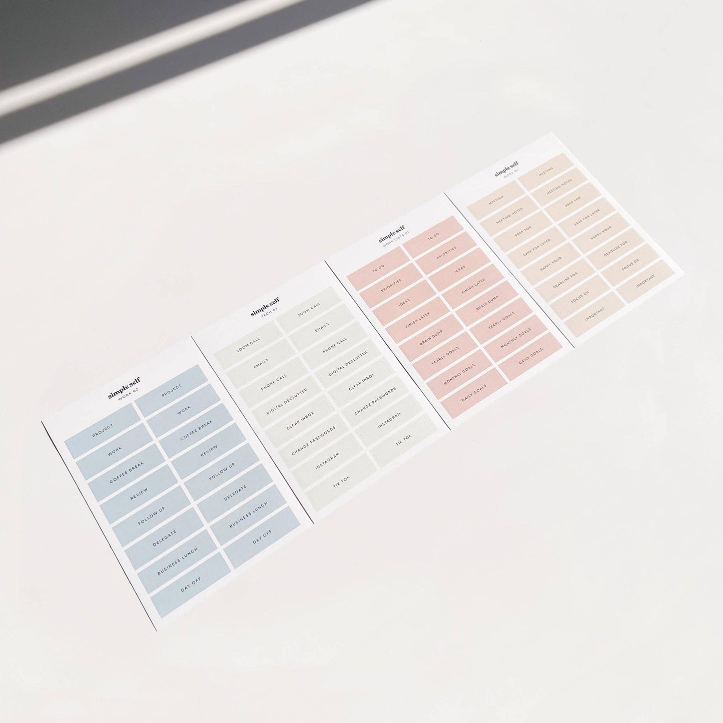 Flat lay of Simple Self Co Work Sticker Set sheets arranged in a row on a white background.