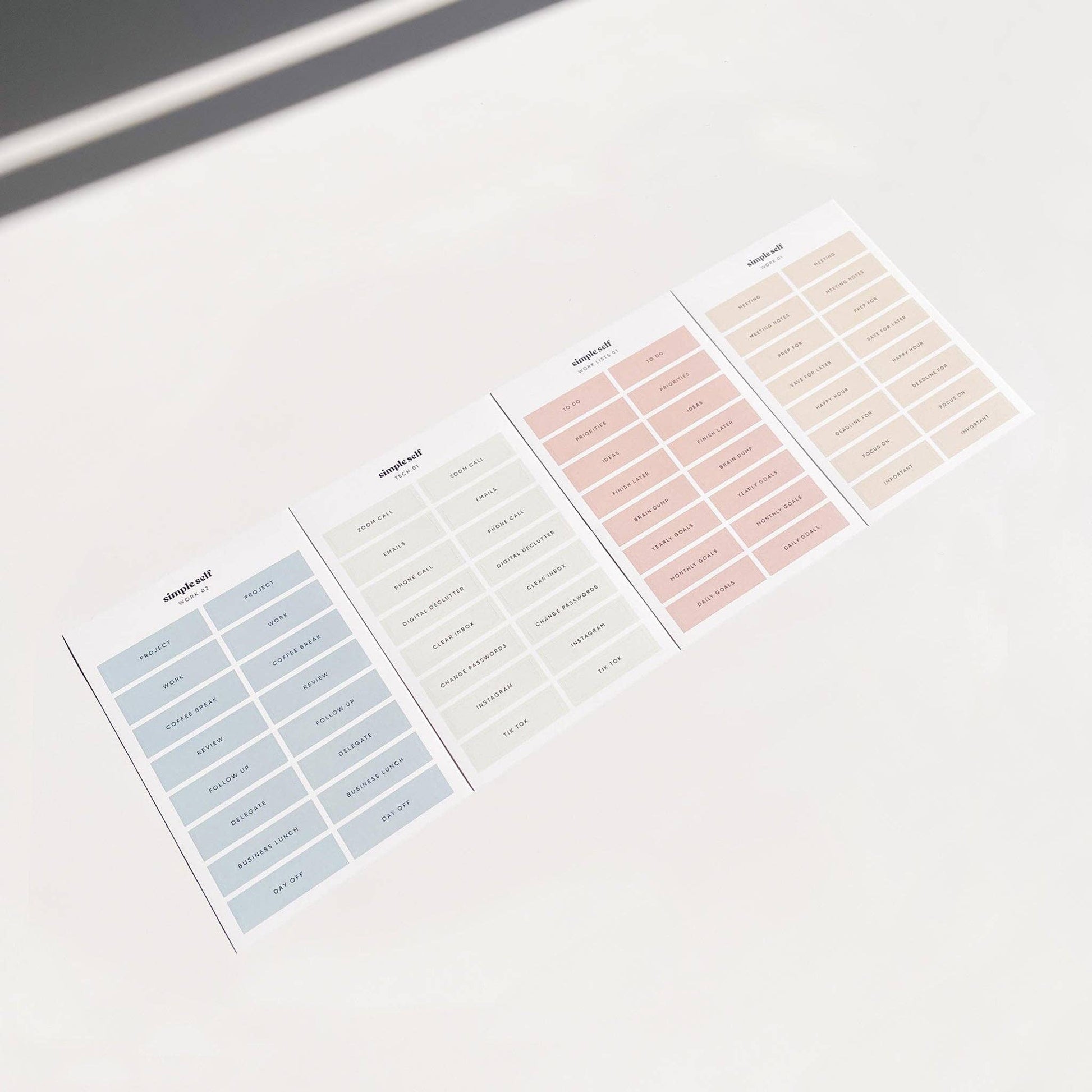 Flat lay of Simple Self Co Work Sticker Set sheets arranged in a row on a white background.